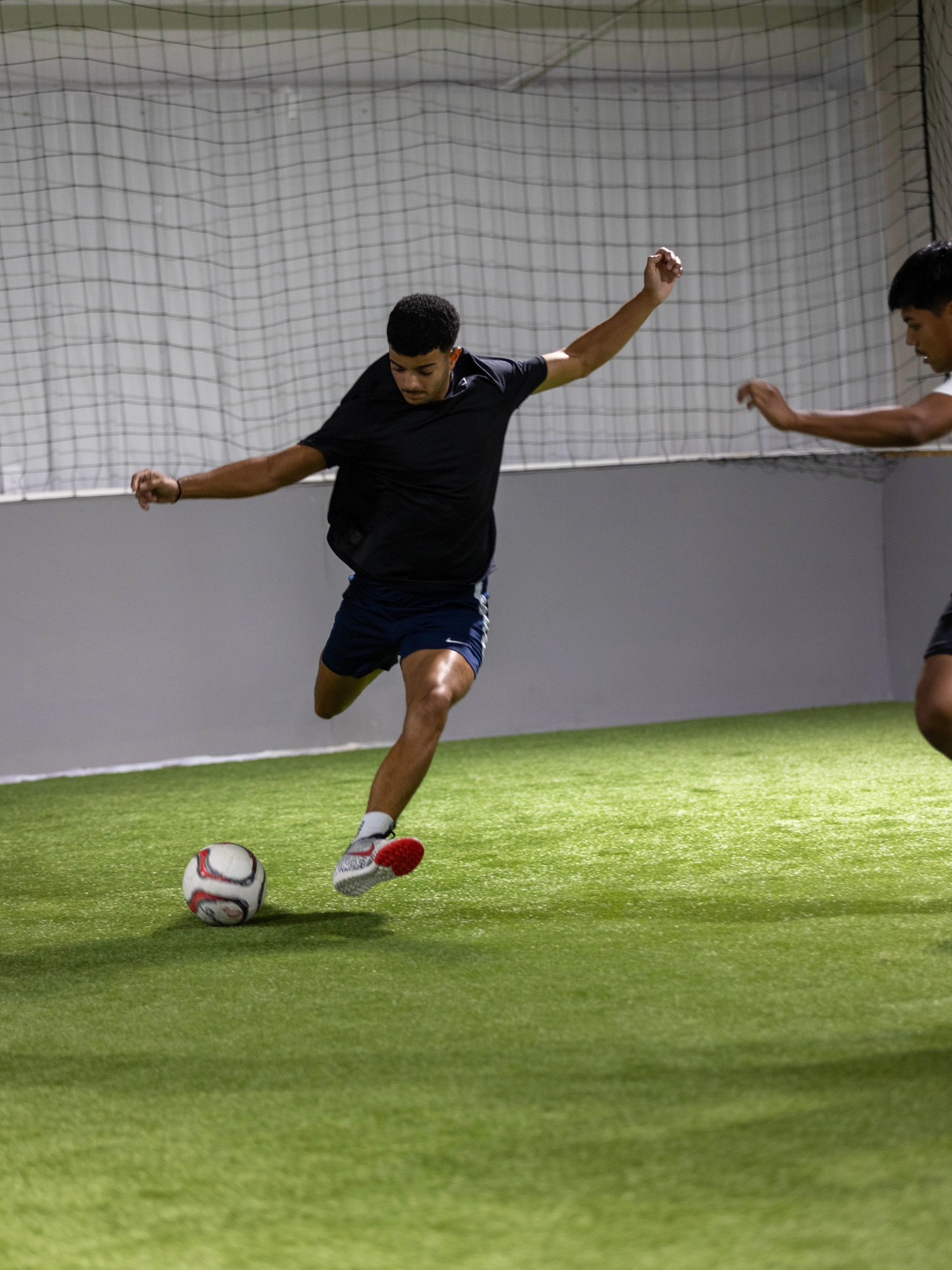 Soccer player dribbling during an indoor CopaFit training session